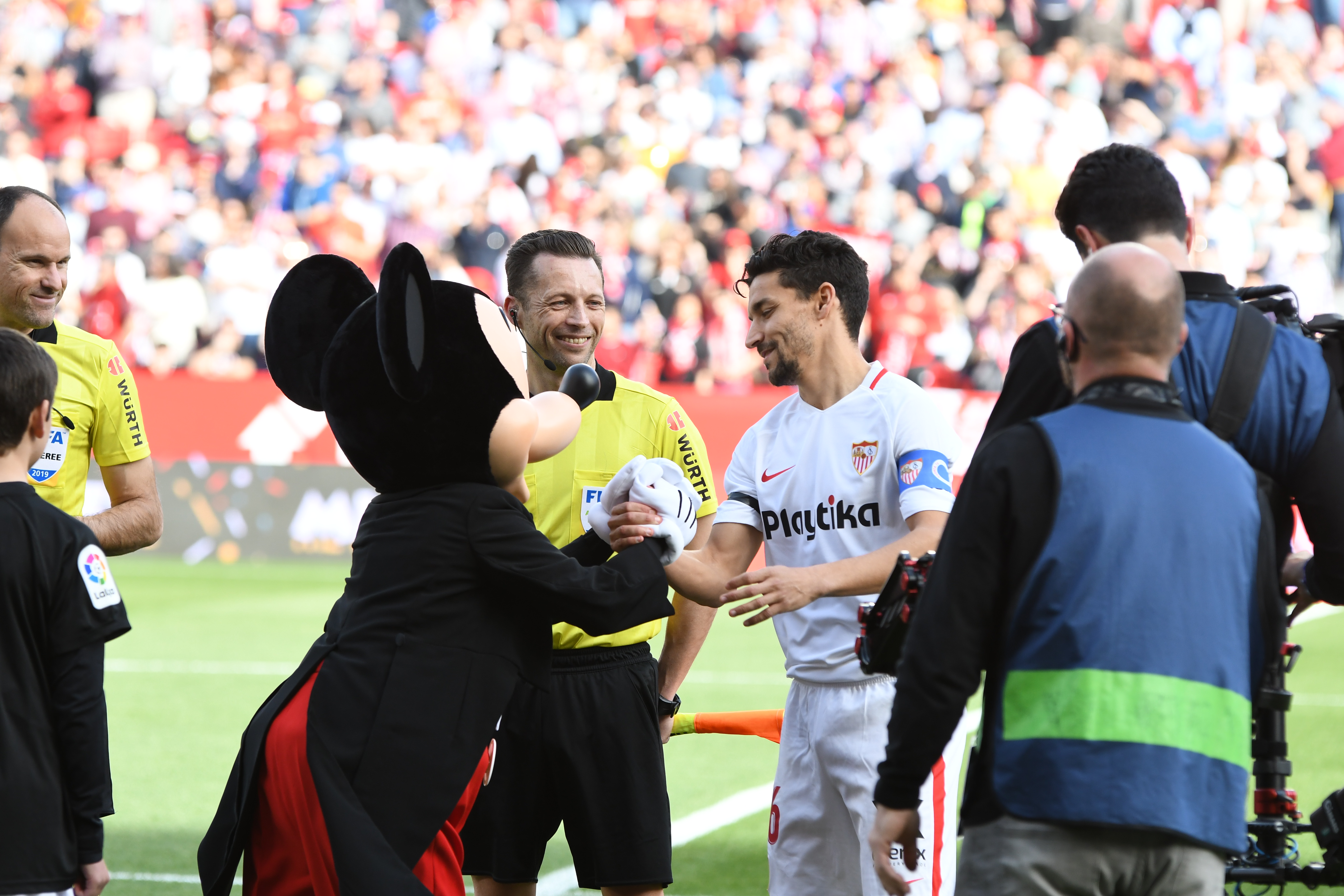 Jesús Navas saluda a Mickey Mouse antes del partido con el FC Barcelona
