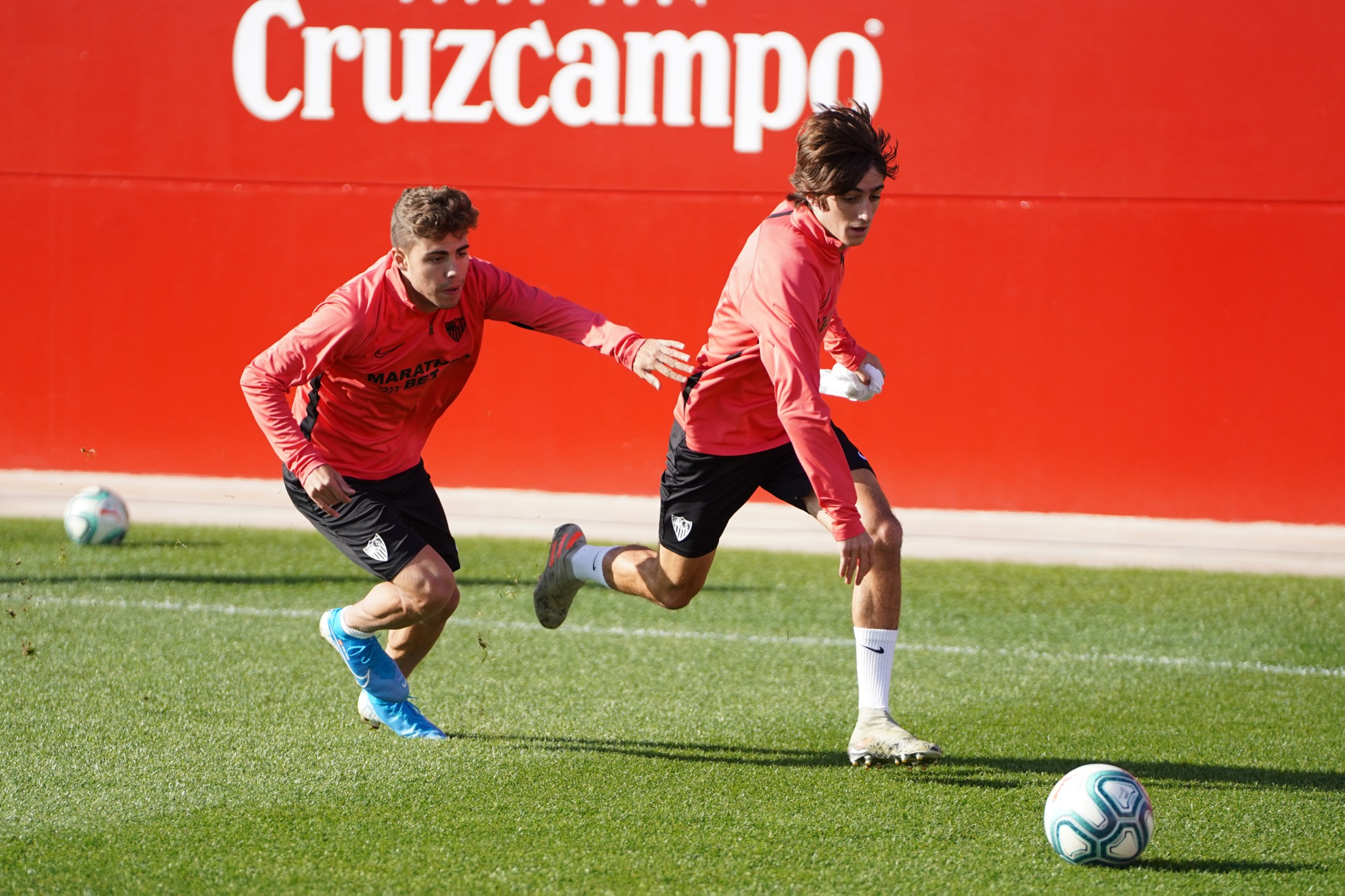 Bryan and Pozo battle for the ball during training