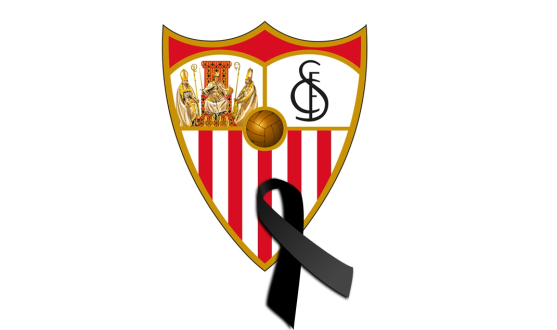 Sevilla FC's crest with a black ribbon
